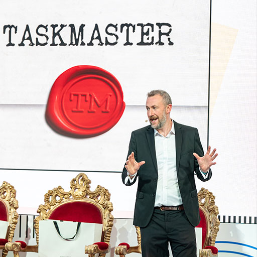 Alex Horne performing at a function